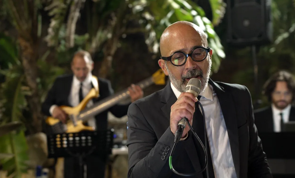 Salvo Samaritano interpreta "Io che amo solo te" a Costa Ponente di Capo Gallo. Sullo sfondo, sfocati, pianista e bassista